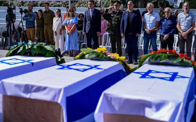 Mourners gather at the site of a missile strike in Bat Yam that killed five Ukrainian citizens, following an Iranian attack last week, June 30, 2025. (Avshalom Sassoni/Flash90)