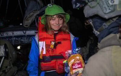 An Israeli soldier offers activist Greta Thunberg water and a pastrami sandwich after the military intercepted and boarded the boat on which she and other activists were seeking to break Israel's blockade on Gaza, early on June 9, 2025. (Foreign Ministry)