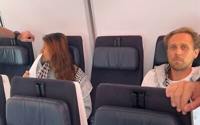 Activists from the Madleen boat, Rima Hassan (left) and Reva Viard, seen on a plane departing Israel after they were deported on June 12, 2025. (Foreign Ministry/X)