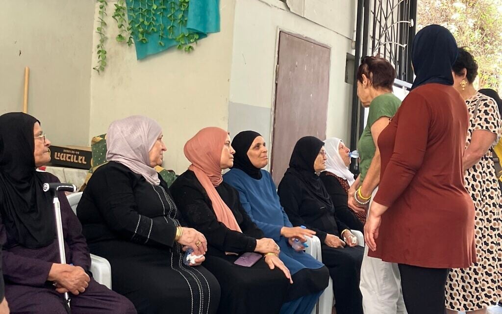 Jewish women pay their condolences to mourners in the Khatib family who lost four female relatives in the June 15, 2025 Iranian ballistic missile strike in Tamra on June 18, 2025. (Diana Bletter/Times of Israel)