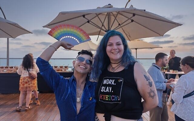 Dillon Perez (L) and Yoanna Chaya Kollin at the closing party of Jewish Federations of North America’s LGBTQ+ Pride Mission to Israel, June 12, 2025 (Zev Stub/Times of Israel)