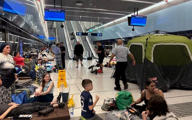 Residents seeking shelter from Iranian missile attacks in Ramat Gan's Bialik Light Rail Station, June 16, 2025. (Ariela Karmel)