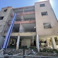 Remains of the building where the Rotstein family lived next to which an Iranian missile landed in the northern city of Haifa on June 15, 2025, photographed on June 16, 2025. (Sue Surkes/Times of Israel)