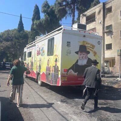 A Chabad bus issues prayers for the speedy recovery of people injured in an Iranian missile attack, for the defeat of the Iran-backed Hamas terror group, and the redemption of the People of Israel, in Haifa, northern Israel, June 16, 2025. (Sue Surkes/Times of Israel)