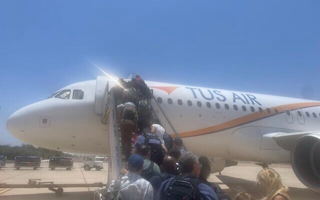 Israelis boarding a Tus Airlines plane bound for Athens from Aqaba, Jordan, on June 24, 2025 (Jessica Steinberg/Times of Israel)