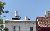 A man suspected of murdering his 80-year-old mother barricades himself on the roof of an apartment building in Rehovot on June 12, 2025. (Screenshot/Ynet)