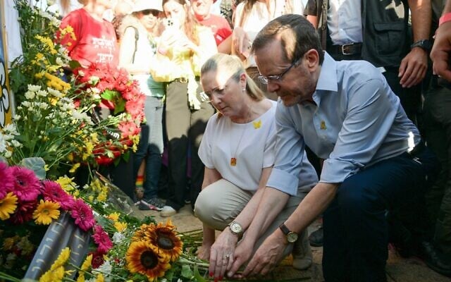 President Isaac Herzog (right) and his wife Michal lay a wreath at the site of the murder of 15-year-old Shira Banki 10 years ago, at the Jerusalem Pride Parade, June 5, 2025. (Maayan Toaf/GPO)