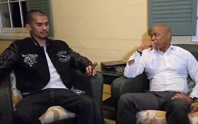 Antisemitic streamer Sneako (left) and New York City Mayor Eric Adams smoke cigars at Gracie Mansion. (Screenshot via JTA)