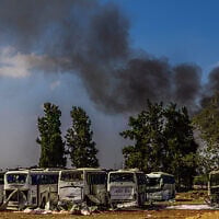 Firefighters work at a site hit by a missile launched from Iran in central Israel on June 17, 2025. (Eli Katzoff/Times of Israel)