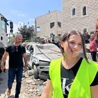 Doaa Hmade (right), volunteer with the Home Front Command and Tamra municipality, stands on the street in Tamra where a Iranian ballistics missile struck a house, killing four women on June 15, 2025. (Diana Bletter/Times of Israel)