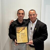 Eli Sharabi, left, and his brother Sharon Sharabi in London, where Eli Sharabi received the Golden Book Award on June 23, 2025, for breaking the record for the number of copies sold for his book 'Hostage.' (Courtesy)