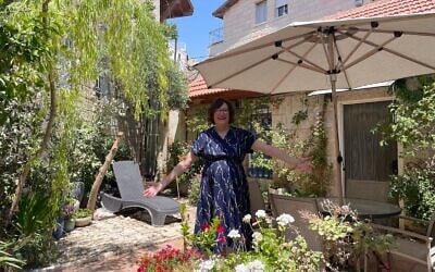 Jewish educator Yiscah Smith in her garden in Jerusalem on May 22, 2025. (Rossella Tercatin/Times of Israel)