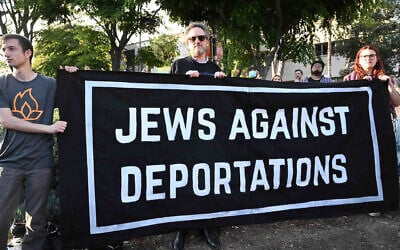 Three individuals hold a sign reading 'Jews Against Deportations' during an interfaith vigil in Los Angeles on June 10, 2025. (Keith Birmingham/MediaNews Group/Pasadena Star-News via Getty Images via JTA)
