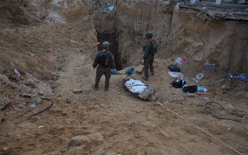 IDF troops remove the body of a Hamas operative from a tunnel running underneath the European Hospital in southern Gaza's Khan Younis, June 7, 2025. (Israel Defense Forces)
