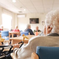 Illustrative: A woman looks out at her friends at a nursing home. (iStock by Getty Images)