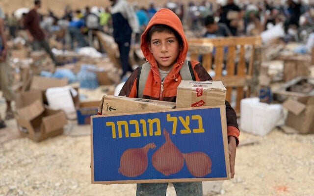 A Palestinian picks up aid at a Gaza Humanitarian Foundation distribution center on June 8, 2025. (GHF)