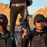 Yasser Abu Shabab (right) and members of his gang in Gaza are seen in an undated video posted by the group. (screen capture: Facebook, 27a clause of the copyright law)