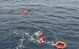 Crew members said to be from cargo ship Eternity C, which sank after being attacked, are seen at sea during a rescue operation, off Yemen, in this handout image released on July 9, 2025. (Diaplous/Handout via REUTERS)