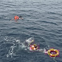 Crew members said to be from cargo ship Eternity C, which sank after being attacked, are seen at sea during a rescue operation, off Yemen, in this handout image released on July 9, 2025. (Diaplous/Handout via REUTERS)