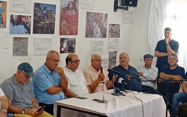 Sakhnin Mayor Mazen Ghanayim (4th from left) speaks during an Arab community press conference in Jaffa, July 27, 2025. (Noam Lehmann/Times of Israel)