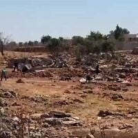 Settlers hurl stones, reportedly during clashes with Palestinians in the West Bank town of Sinjil on July 11, 2025. (Screen capture: Al-Jarmaq News)
