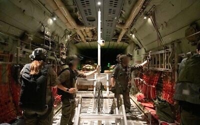 Israeli Air Force staff prepare boxes of humanitarian aid ahead of an airdrop in the Gaza Strip, July 26, 2025. (IDF)