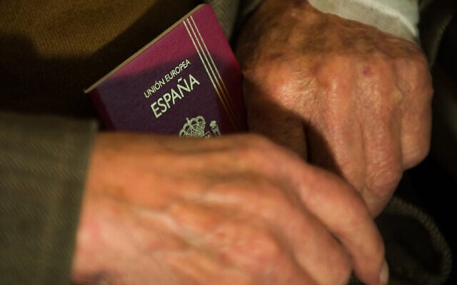 ILLUSTRATIVE: Man holds Spanish passport, June 9, 2009. (LEON NEAL / AFP) ILLUSTRATIVE: Man holds Spanish passport, June 9, 2009. (LEON NEAL / AFP)