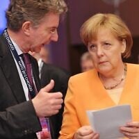 German Chancellor Angela Merkel (R) chats with her foreign policy adviser Christoph Heusgen before the opening session of the North Atlantic Council during the NATO Summit on May 20, 2012, at McCormick Place in Chicago. (Photo by MANDEL NGAN / AFP)