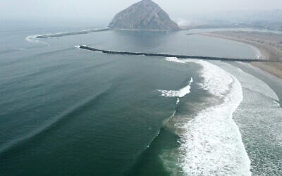 An aerial view of Pacific Ocean waves breaking near Morro Rock (TOP) in a marine area which is currently recommended for exclusion from the proposed Chumash Heritage National Marine Sanctuary along California's Central Coast on September 20, 2023. (Photo by Mario Tama/Getty Images via AFP)