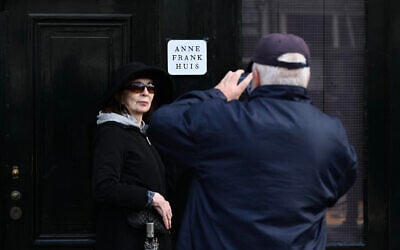 A man takes a picture of a woman in front of the Anne Frank House museum in Amsterdam, on April 4, 2024. (JOHN THYS / AFP)