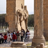 People tour through the ruins of ancient Persepolis, which served as the capital of the ancient Achaemenid Persian Empire in southern Iran on May 13, 2024. (Atta Kenare/AFP)