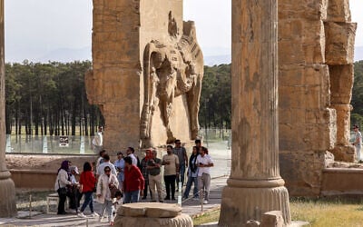 People tour through the ruins of ancient Persepolis, which served as the capital of the ancient Achaemenid Persian Empire in southern Iran on May 13, 2024. (Atta Kenare/AFP)