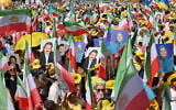 Protesters hold pictures of Maryam Rajavi and Massoud Rajavi, leaders of the People's Mujahedin of Iran (MEK), during a demonstration in Berlin, on June 29, 2024 (RALF HIRSCHBERGER / AFP)