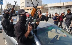 Members of Hamas's armed wing, the Ezzedine al-Qassam Brigades, take part in a military parade along a street in Deir al-Balah, in the central Gaza Strip, on January 19, 2025. (BASHAR TALEB / AFP)