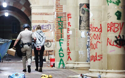 A California Highway Patrol (CHP) officer detains a protestor while clearing a pro-Palestinian, anti-Israel encampment after dispersal orders were given at the University of California, Los Angeles (UCLA) campus, on May 2, 2024 in Los Angeles, California. (MARIO TAMA / GETTY IMAGES NORTH AMERICA / Getty Images via AFP) A California Highway Patrol (CHP) officer detains a protestor while clearing a pro-Palestinian, anti-Israel encampment after dispersal orders were given at the University of California, Los Angeles (UCLA) campus, on May 2, 2024 in Los Angeles, California. (MARIO TAMA / GETTY IMAGES NORTH AMERICA / Getty Images via AFP)