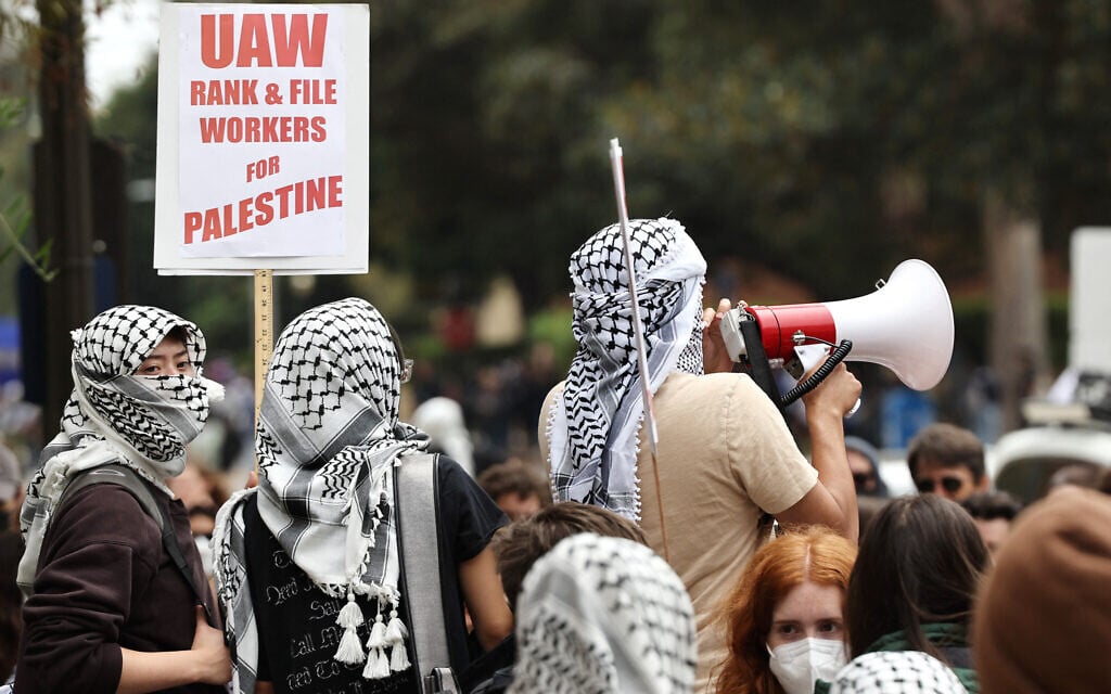Protesters gather with a sign reading 'UAW Rank & File Workers For Palestine' after police cleared an encampment of pro-Palestinian, anti-Israel protestors on the UCLA (University of California, Los Angeles) campus on May 23, 2024 in Los Angeles, California. (Mario Tama/Getty Images North America via AFP) Protesters gather with a sign reading 'UAW Rank & File Workers For Palestine' after police cleared an encampment of pro-Palestinian, anti-Israel protestors on the UCLA (University of California, Los Angeles) campus on May 23, 2024 in Los Angeles, California. (Mario Tama/Getty Images North America via AFP)