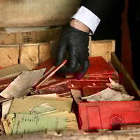 Handout picture released on May 11, 2025 by Argentina's Supreme Court showing authorities checking Nazi documentation found in boxes stored at the basement of the Justice Palace, in Buenos Aires. (Handout / ARGENTINA'S SUPREME COURT OF JUSTICE / AFP)TS