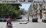 A man rides a motorbike at the entrance of the Yarmuk camp for Palestinian refugees and their descendants in southern Damascus on May 22, 2025. (LOUAI BESHARA / AFP)