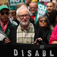 Jeremy Corbyn, center, holds a banner as he takes part in the 'No More Austerity 2.0' march in central London on June 7, 2025, hosted by The People's Assembly Against Austerity. (HENRY NICHOLLS / AFP)