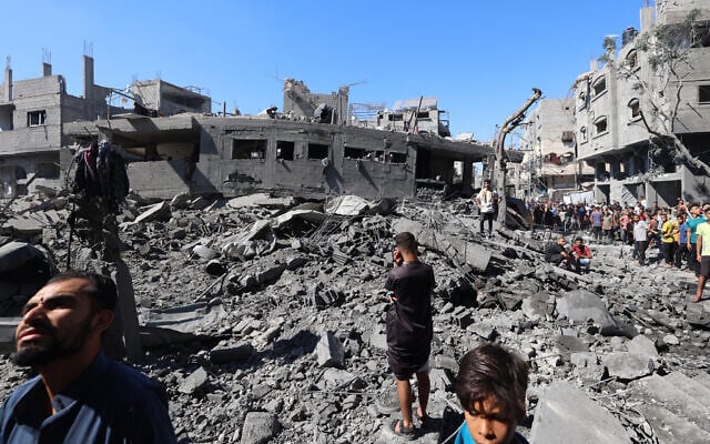 Palestinians inspect the damage after an Israeli strike in the Al-Bureij camp in the central Gaza Strip on July 4, 2025. (Photo by Eyad BABA / AFP)