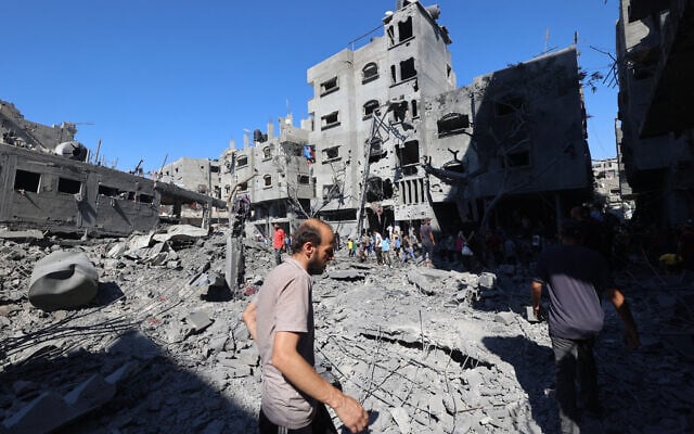 Palestinians inspect the damage after an Israeli strike in the Al-Bureij camp in the central Gaza Strip on July 4, 2025. (Photo by Eyad BABA / AFP)