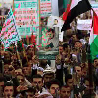 Yemenis carry a portrait of Houthi leader Abdul Malik al-Houthi during a rally in the Houthi-run capital Sanaa, Yemen, on July 4, 2025. (Mohammed HUWAIS / AFP)