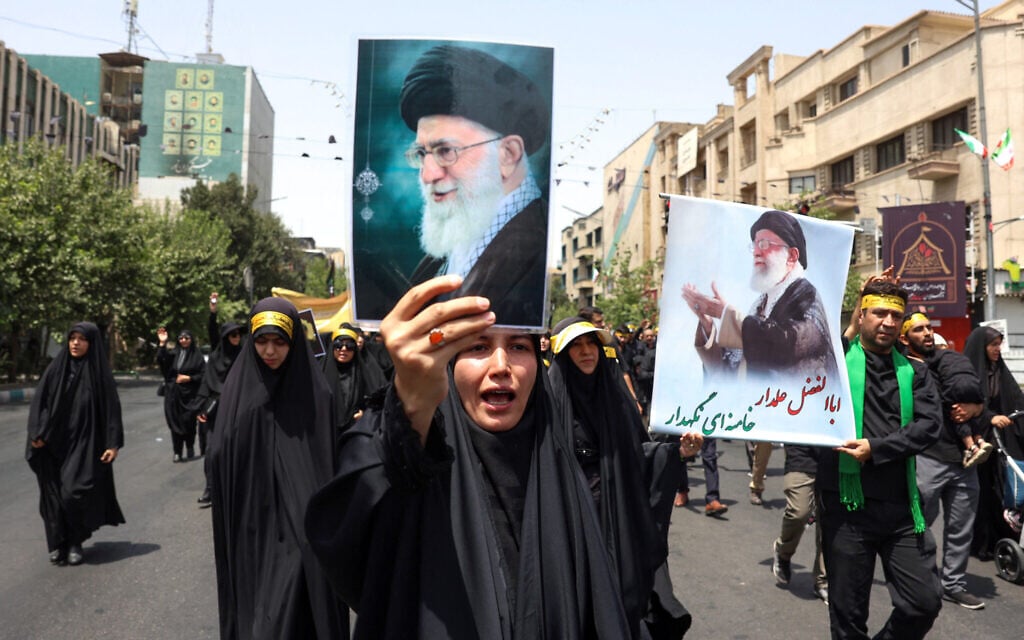 An Iranian woman holds a picture of Supreme Leader Ayatollah Ali Khamenei during a rally in his support, as Shiite Muslims attend the "Tasua" mourning ritual to commemorate martyrdom of Prophet Mohammad's grandson Imam Hussein, during the Islamic month of Muharram ahead of Ashura on July 5, 2025. (AFP)