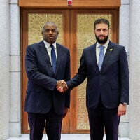 Syria's interim president, Ahmed al-Sharaa, (R) welcomes then-British Foreign Secretary David Lammy in Damascus, Syria on July 5, 2025. (SANA/AFP)