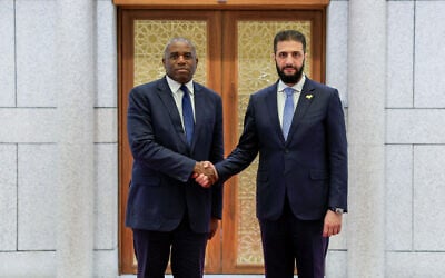 Syria's interim president, Ahmed al-Sharaa, (R) welcomes British Foreign Secretary David Lammy in Damascus, Syria on July 5, 2025. (SANA/AFP)