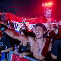 Fans of Croatian nationalist singer Marko Perkovic Thompson gather at the Zagreb hippodrome during a concert by the singer, who is known for his sympathies for the country's World War II Nazi-allied regime, to an expected crowd of some 450,000 people on July 5, 2025. (Damir Sencar/AFP)