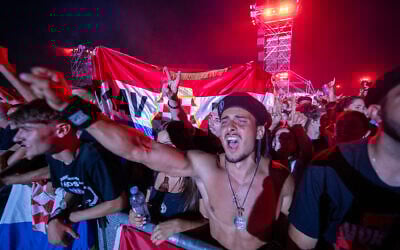 Fans of Croatian nationalist singer Marko Perkovic Thompson gather at the Zagreb hippodrome during a concert by the singer, who is known for his sympathies for the country's World War II Nazi-allied regime, to an expected crowd of some 450,000 people on July 5, 2025. (Damir Sencar/AFP)