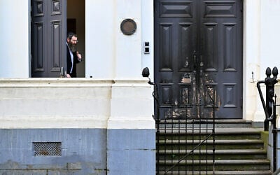 Rabbi Dovid Gutnick speaks to the media next to the burnt front entrance of the East Melbourne Synagogue in Melbourne on July 6, 2025. (William WEST / AFP)