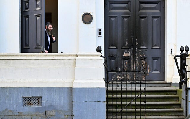 Rabbi Dovid Gutnick speaks to the media next to the burnt front entrance of the East Melbourne Synagogue in Melbourne on July 6, 2025. (William WEST / AFP)