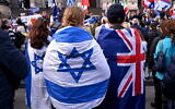 FILE: People wearing flags of Israel and Australia listen to speeches at a rally in Melbourne on July 6, 2025, after the front door of a synagogue was set ablaze. (WILLIAM WEST / AFP)